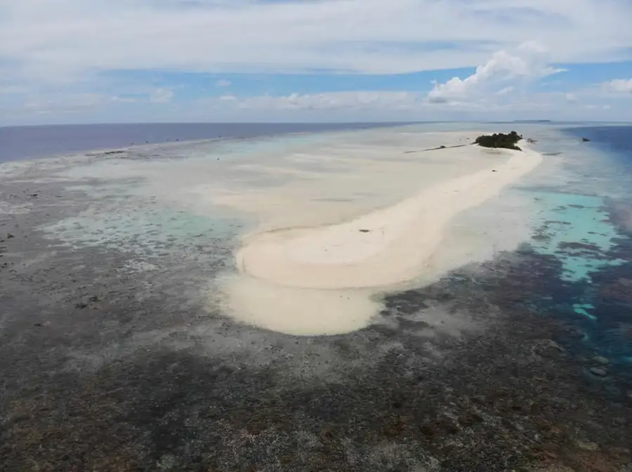 High angle aerial view of an island hopping boat Bihing Angan Water Chalet