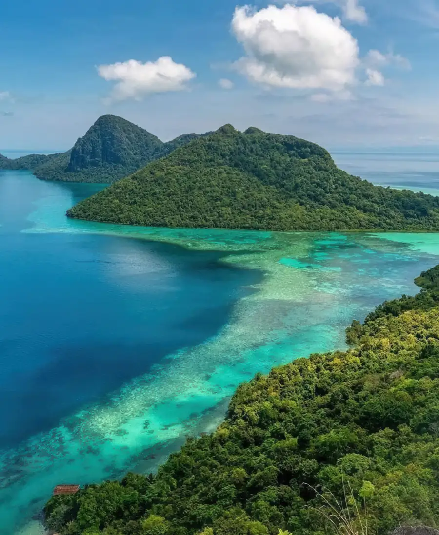 Drone shot of the turquoise lagoons and islands Bihing Angan Water Chalet