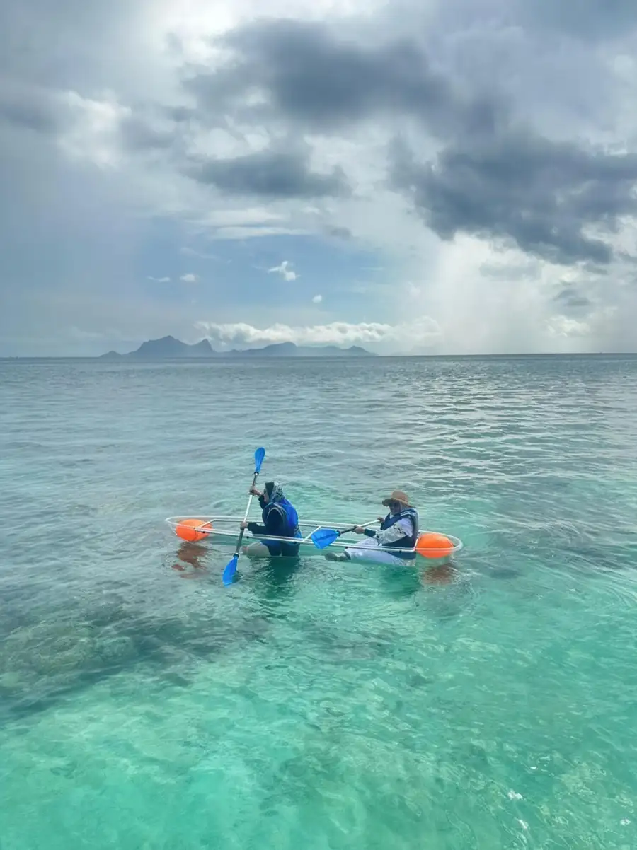 Leisurely sea kayaking near the overwater chalets Bihing Angan Water Chalet